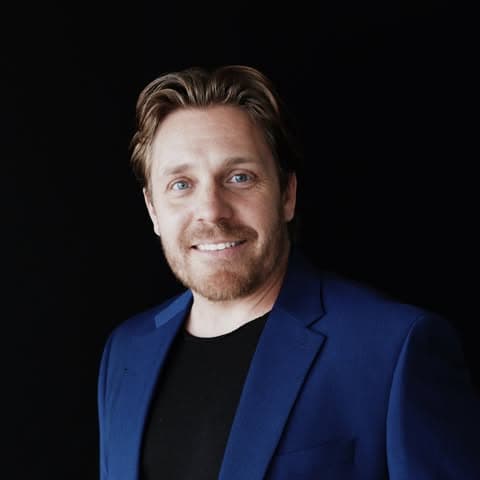 Jason Boley, owner of Medina Mortgage LLC, smiling in a blue blazer